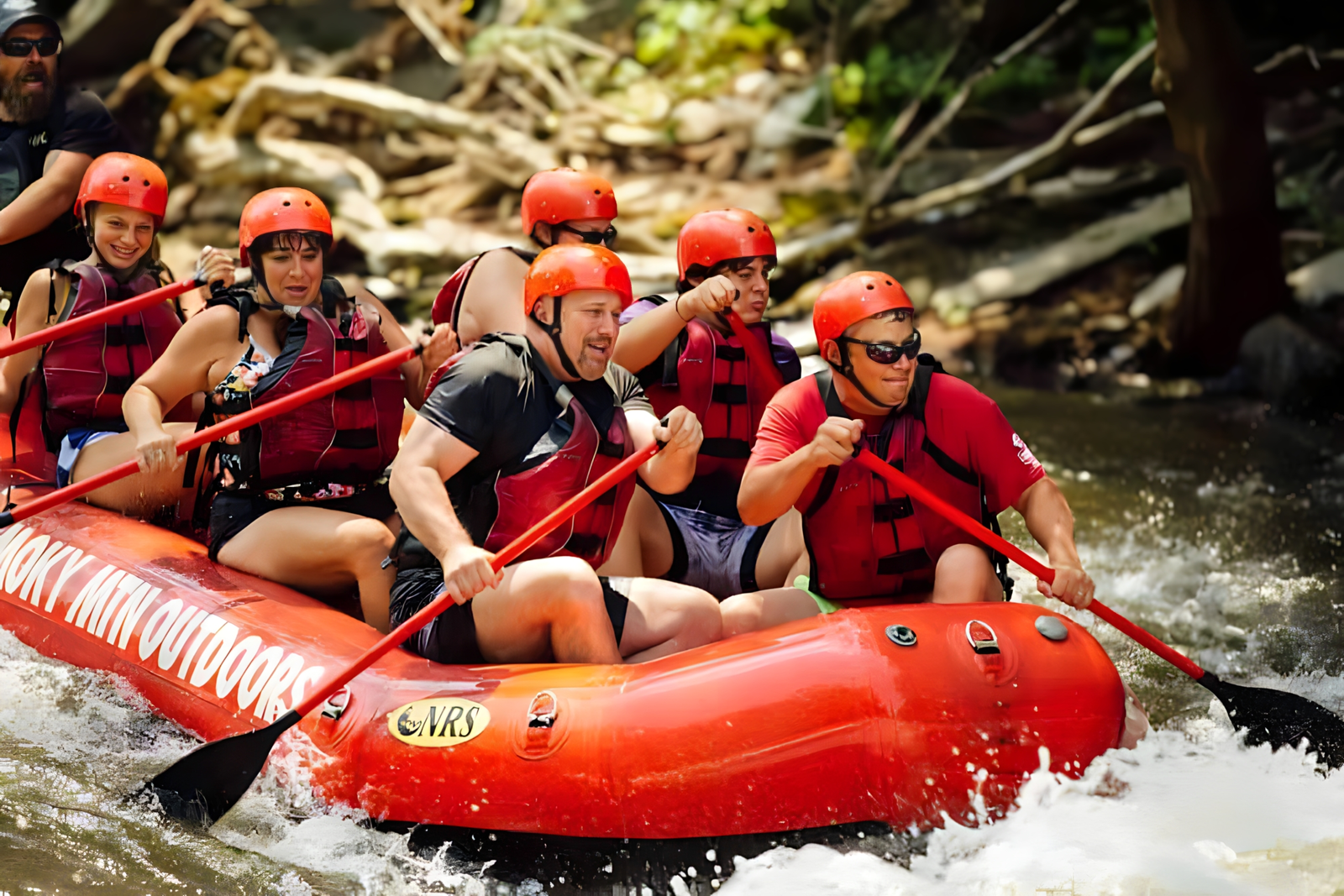 raft full of rafters about to go over a rapid