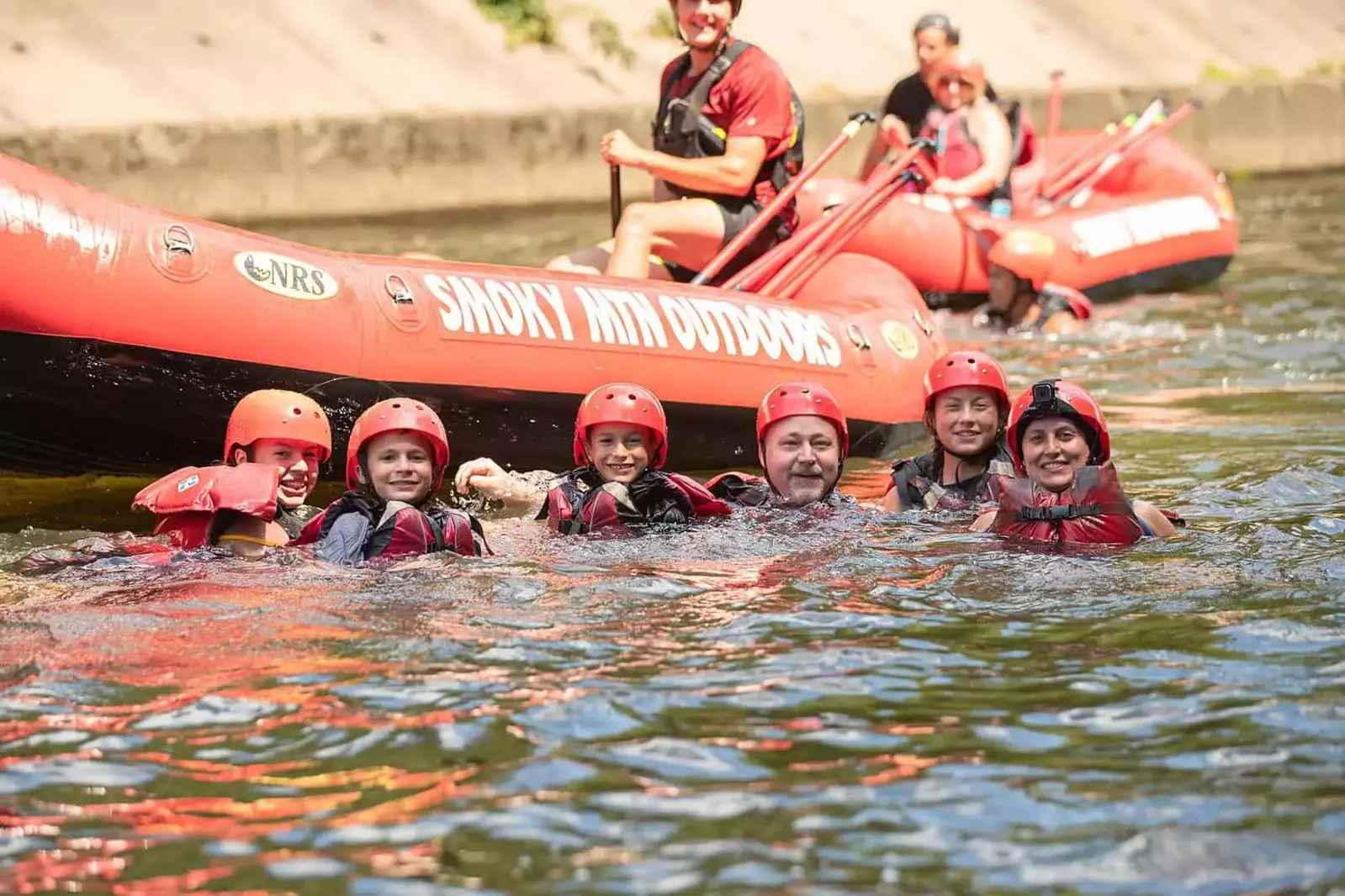rafters floating in water next to raft